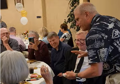 Rick Deezie performing strolling magic for guests at an anniversary party in the Philadelphia suburbs